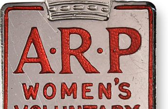 A metal pin badge Women's Voluntary Services