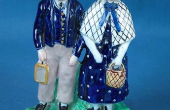 Staffordshire figure depicting a boy and girl standing side by side on an oval base entitled 'GEORGE MULLERS ORPHANS BRISTOL' in black indented capitals, 1890.