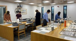 People looking at youth charity records at a workshop